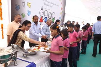 Dignitaries take turns to help serve the food