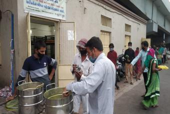 Volunteers help distribute the food